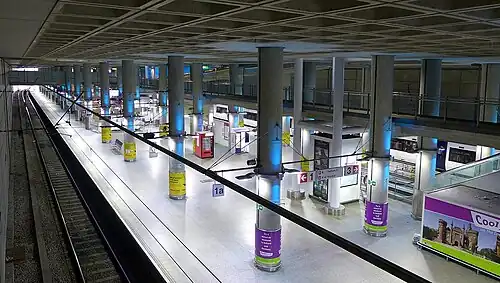 A dark, underground railway station with stylish lighting