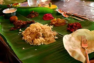 Eating together from a long, wide banana leaf.