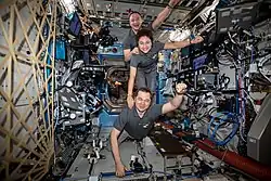 Three astronauts standing on top of each other