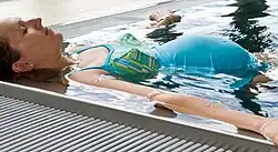 Woman floating in the edge of a pool
